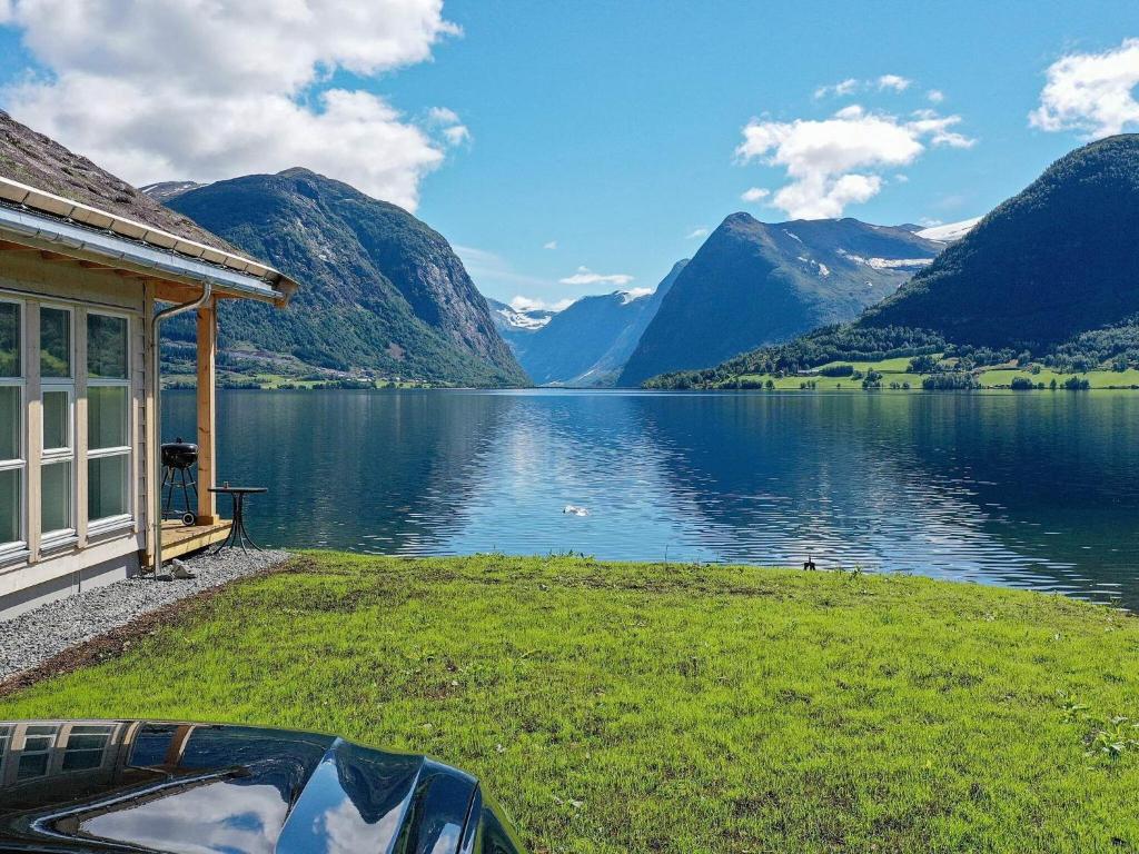 a house with a view of a lake and mountains at Holiday home skei i jølster V in Skei