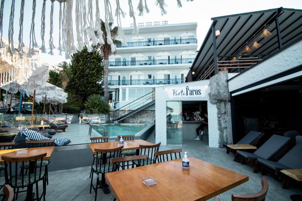 a restaurant with tables and chairs in front of a building at Kiani Akti in Porto Rafti