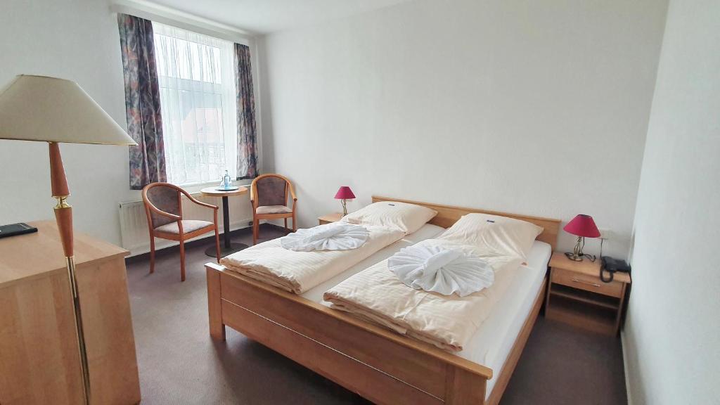 Postel nebo postele na pokoji v ubytování Hotel Zittauer Hütte
