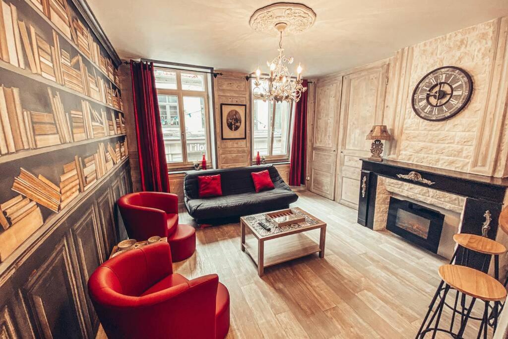 a living room with red chairs and a fireplace at Appartement familial de caractère in Boulogne-sur-Mer