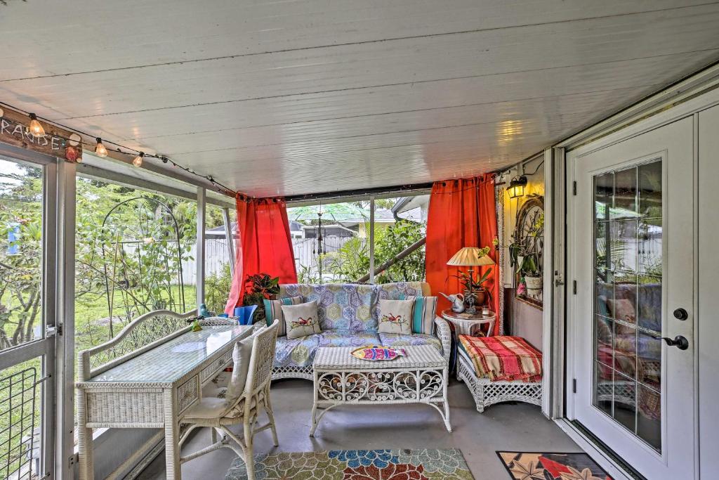 a screened in porch with a table and chairs at Boho-Style Escape with Patio about 3 Mi to Bonita Beach! in Bonita Springs