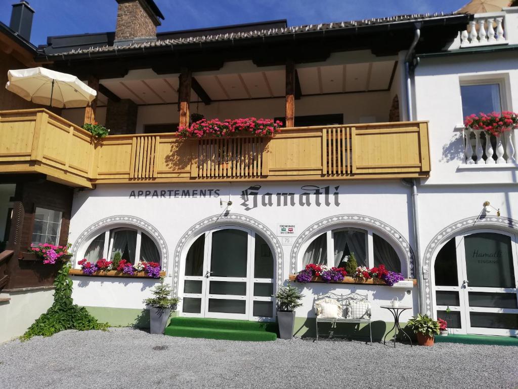 a building with a balcony with flowers on it at Haus Hamatli in Sankt Anton am Arlberg