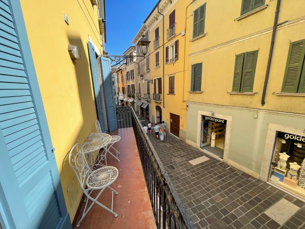 a view of an alley with chairs and buildings at DesenzanoLoft Le Petit Bijou Desenzano in Desenzano del Garda