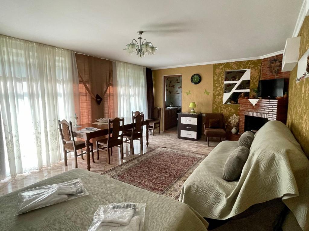 a living room with a couch and a dining room at Garden House in Kvareli