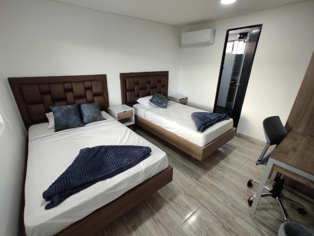 Postel nebo postele na pokoji v ubytování Hostel Boutique Nido de Loros