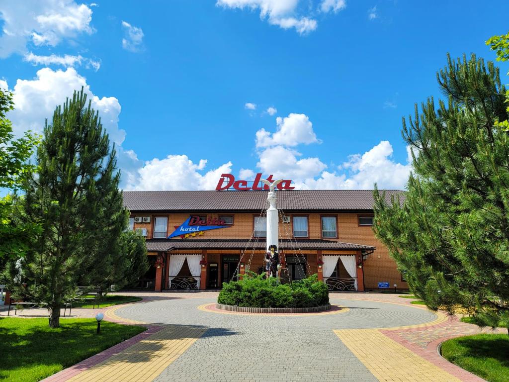 a hotel with a sign on the front of it at Delta Hotel in Vylkove