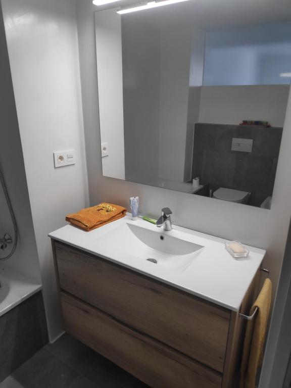 a bathroom with a sink and a mirror at Apartment close to the beach with free parking in Badalona