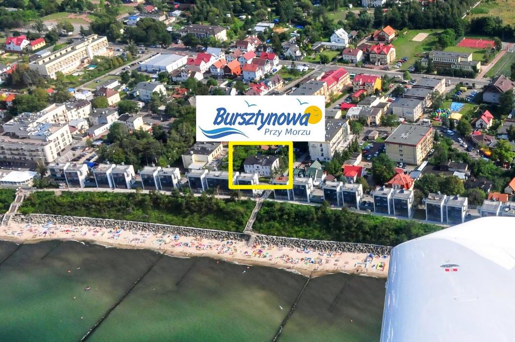 an aerial view of a city with a sign at Bursztynowa Przy Morzu in Ustronie Morskie