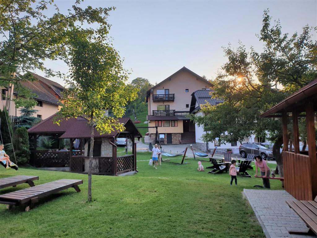 a group of people playing in a park at Pensiunea Sarah Bran in Bran