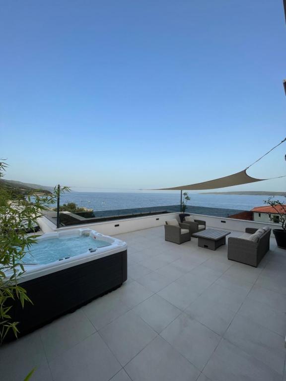 patio con vasca idromassaggio e vista sull'oceano di Exclusive Seafront Suite with jacuzzi a Zavala