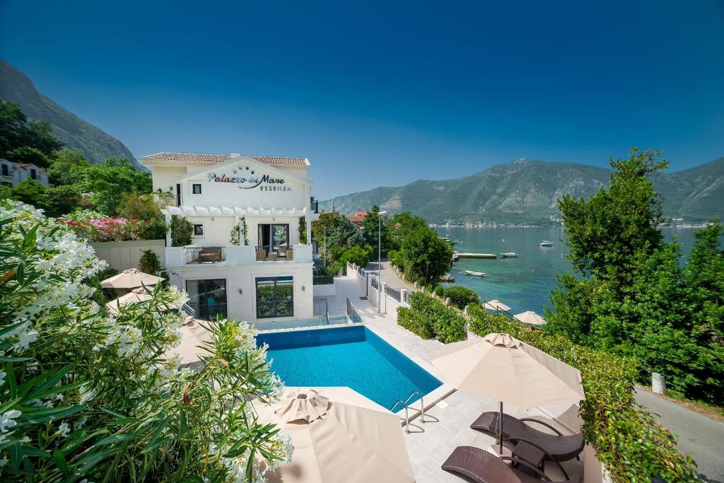 a villa with a swimming pool and a view of the water at Hotel Palazzo del Mare - Essenza in Kotor