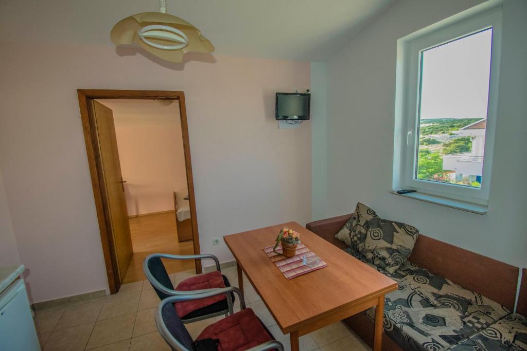 un soggiorno con un tavolo e un divano di Apartments Stef in Kosljun island Pag a Košljun