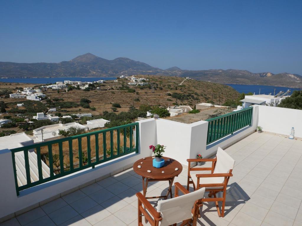 a balcony with a table and chairs and a view at Melide in Tripiti