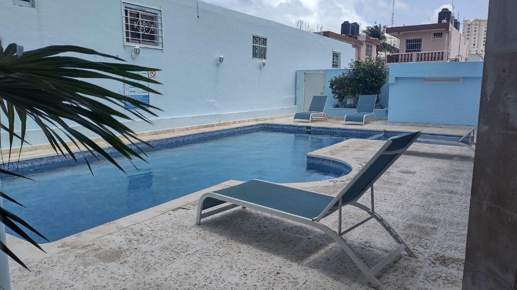 a chair sitting next to a swimming pool at Hacienda de Castilla in Cancún