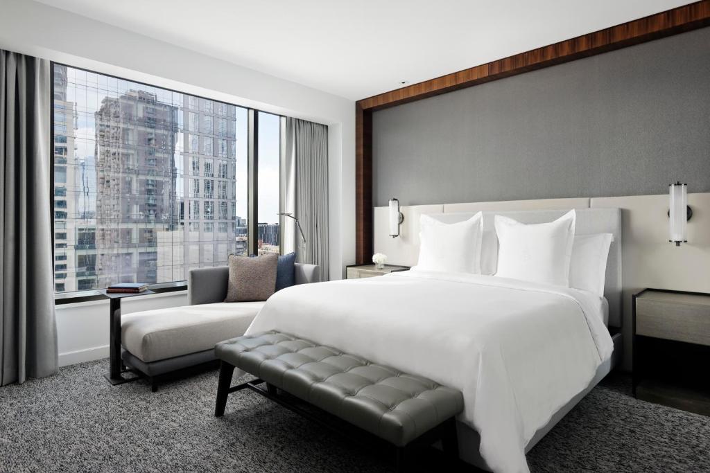 a bedroom with a large white bed and a window at Four Seasons Hotel Denver in Denver