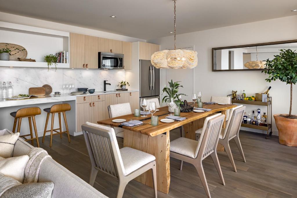 a kitchen and dining room with a wooden table and chairs at 1 Hotel Toronto in Toronto
