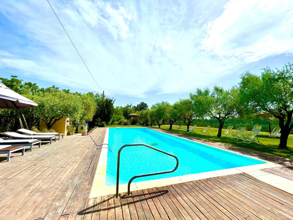 a swimming pool on a wooden deck at Villa Helvetia in Corropoli