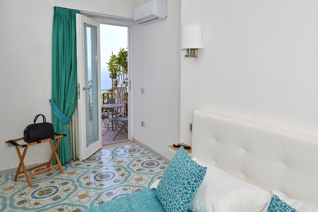 Postel nebo postele na pokoji v ubytování Malafemmena Guest House