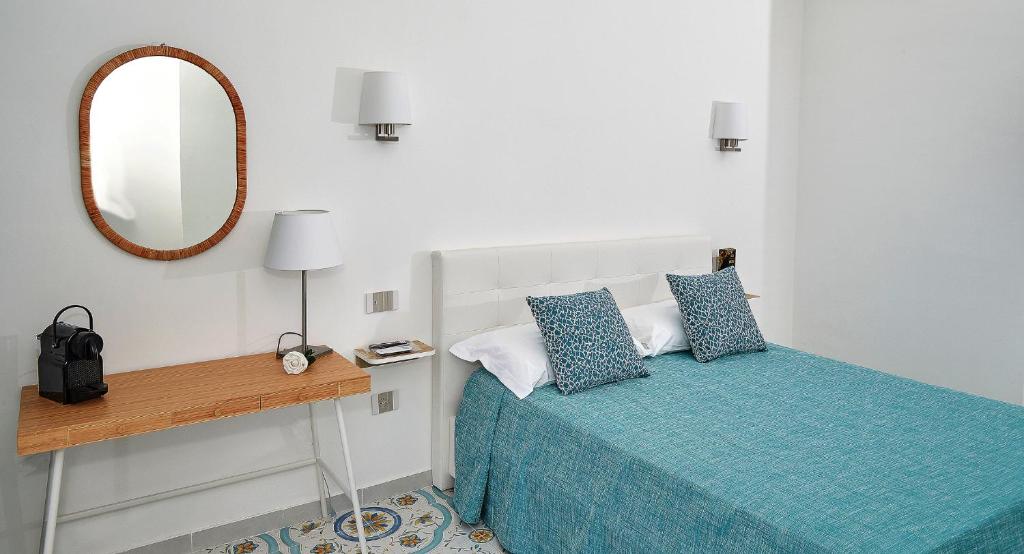 Postel nebo postele na pokoji v ubytování Malafemmena Guest House