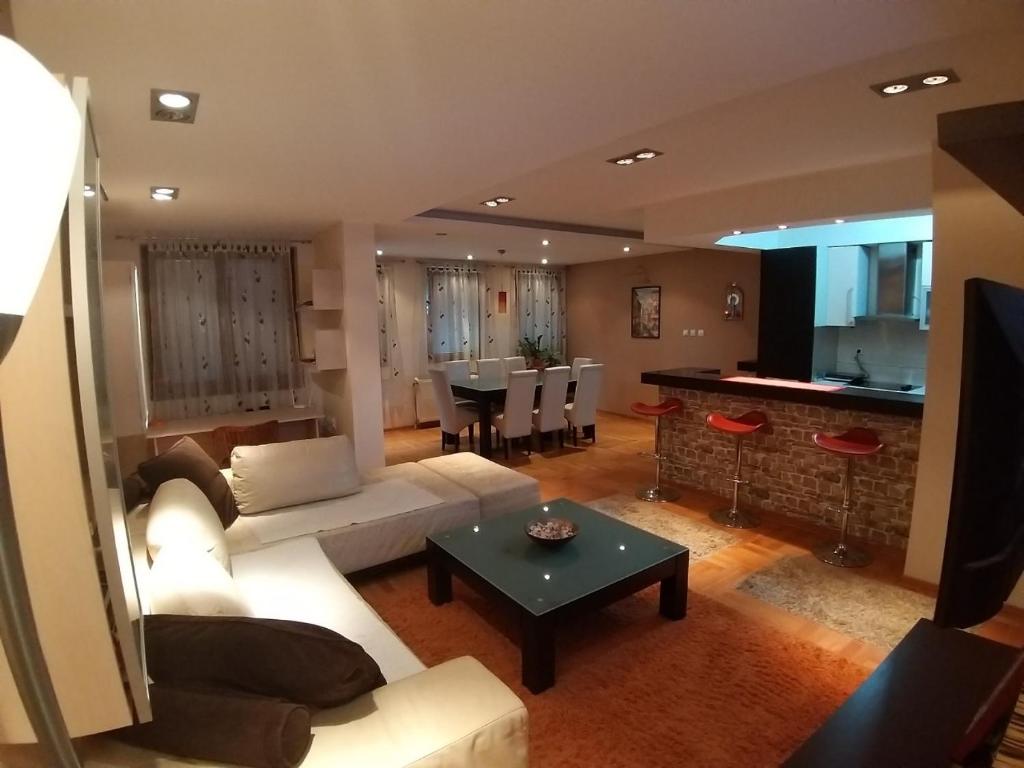 a living room with a couch and a table at Brown Apartment - Niš Center in Niš