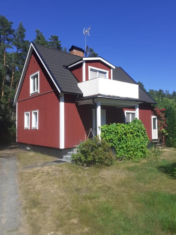 a red house with a black roof at Holiday Home Småland in Fågelfors