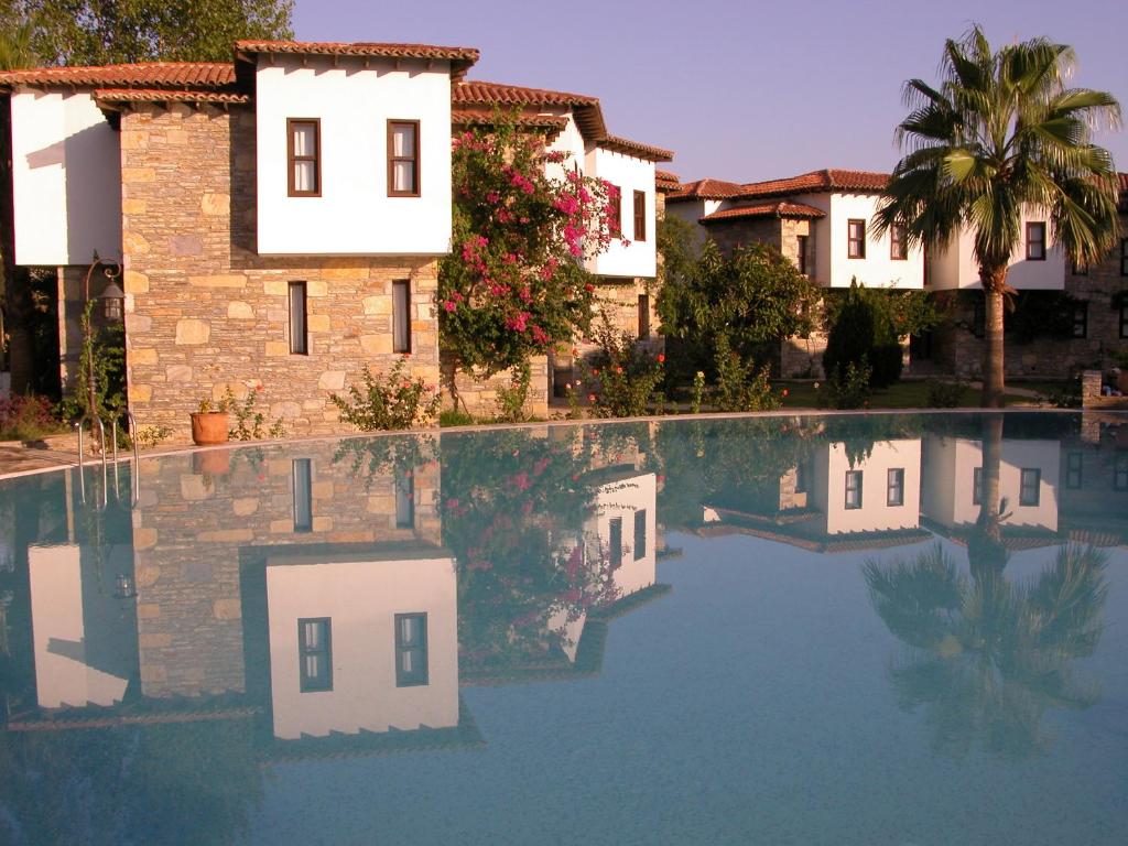 a swimming pool in front of a building at The Osmanli Hani in Dalyan