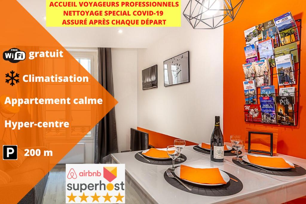 a table with plates of food and a bottle of wine at CLIMATISATION-Hypercentre-PARKING-COSY CARNOT-AVIGNONSMILE in Avignon