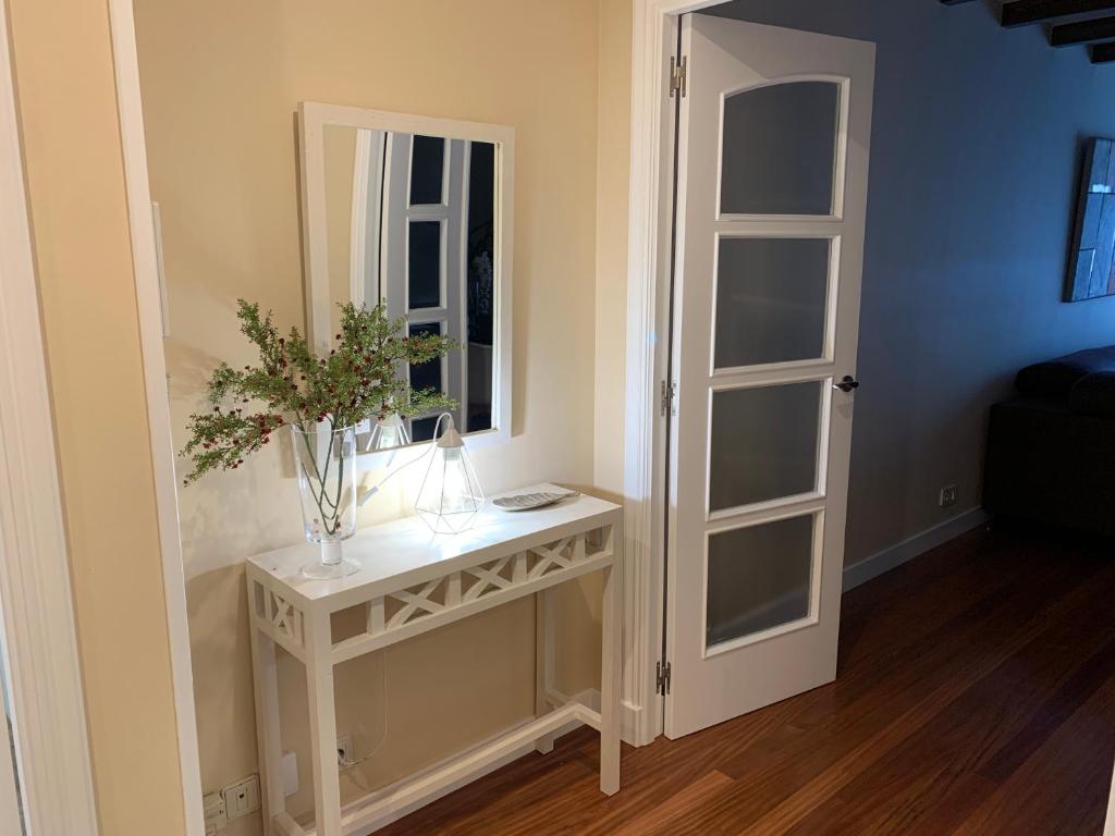 a room with a table with a mirror and a window at Lucky home in Pontevedra