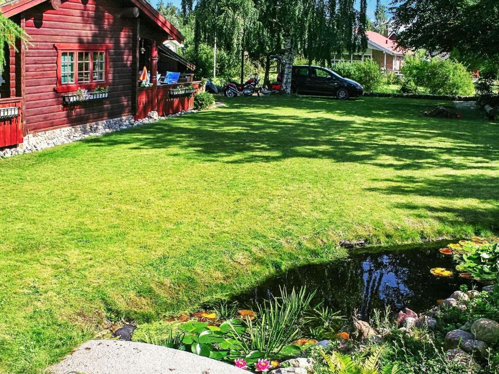 a yard with a pond in front of a house at Holiday home Middelfart II in Middelfart