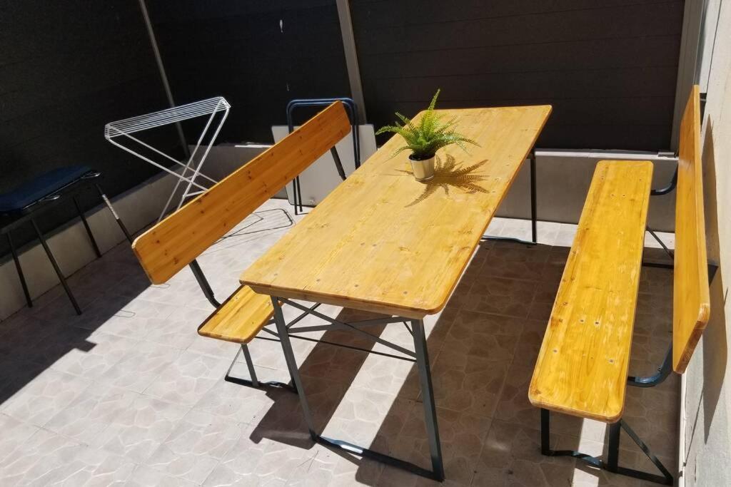 a wooden table with two chairs and a plant on it at Calanques de Sormiou in Marseille