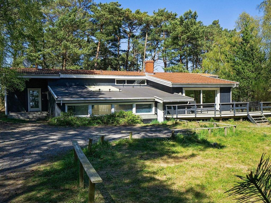 a house with a large yard in front of it at 14 person holiday home in Nex in Snogebæk