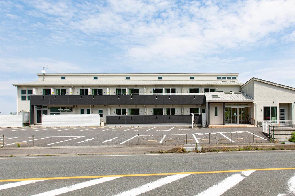 an empty parking lot in front of a building at Tabist Hotel Takagiya Iwaki in Hisanohama