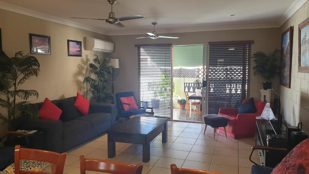 a living room with a couch and chairs and a table at A City Retreat, 2BR Apartment - Reid Park -Townsville in Townsville