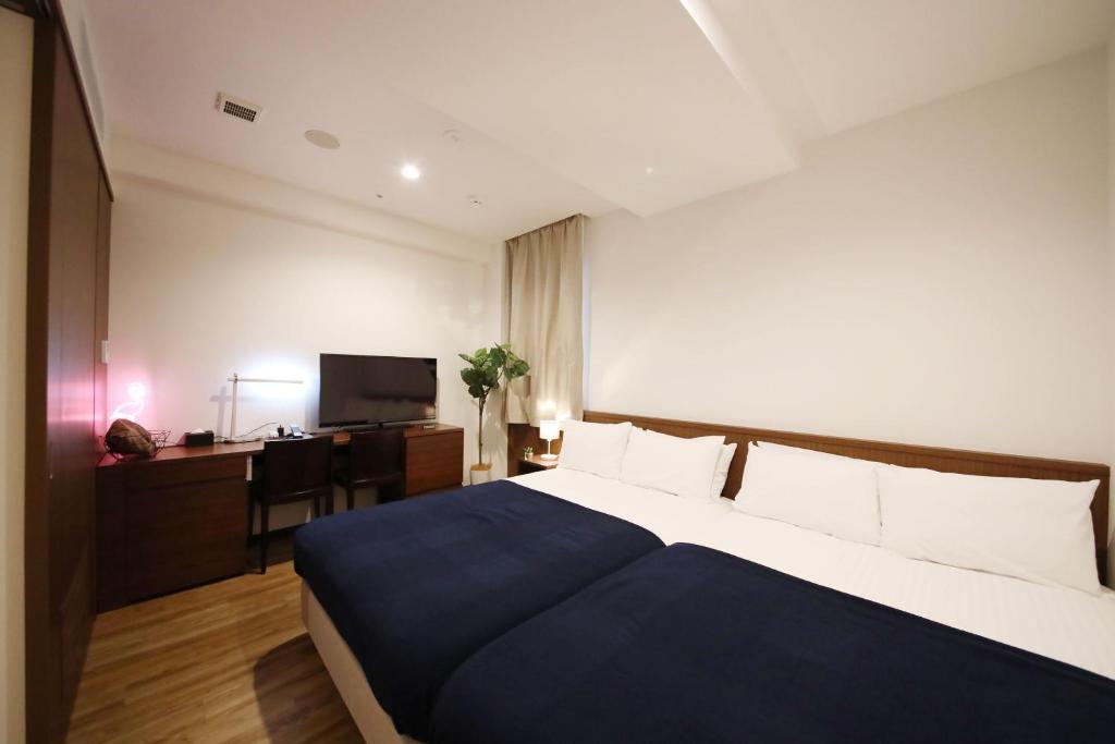 Postel nebo postele na pokoji v ubytování ZONK HOTEL Hakata