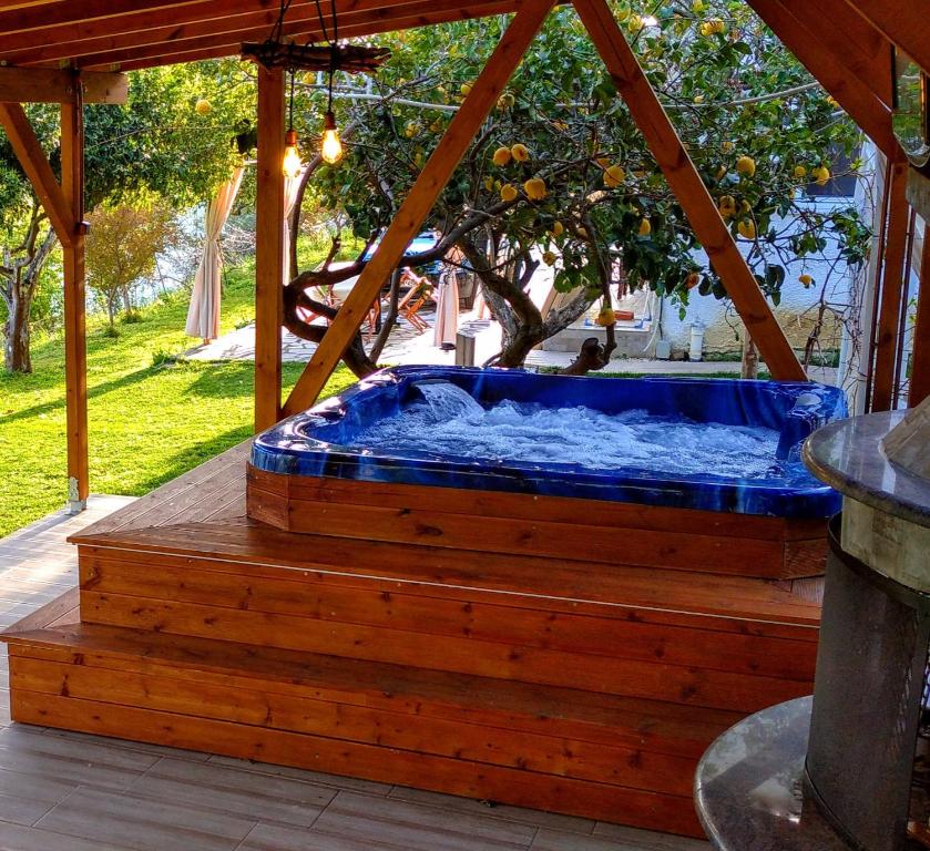 a hot tub sitting on a wooden deck at The Elysian at Nicopolis jacuzzi in Nikópolis