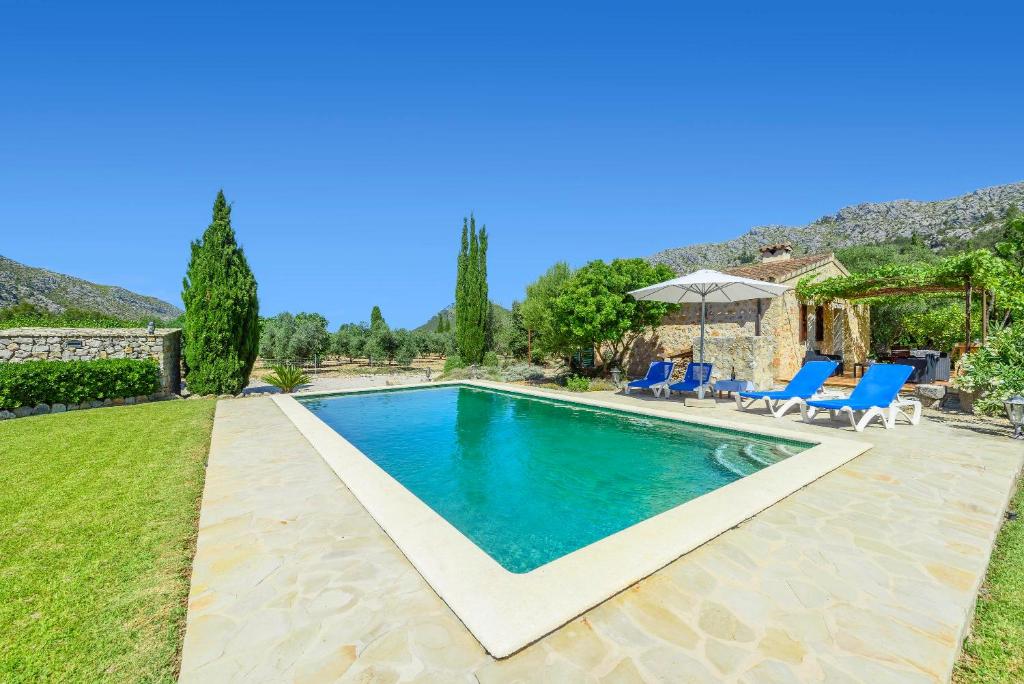 a swimming pool in the backyard of a villa at Finca Can Solivellas in Pollença