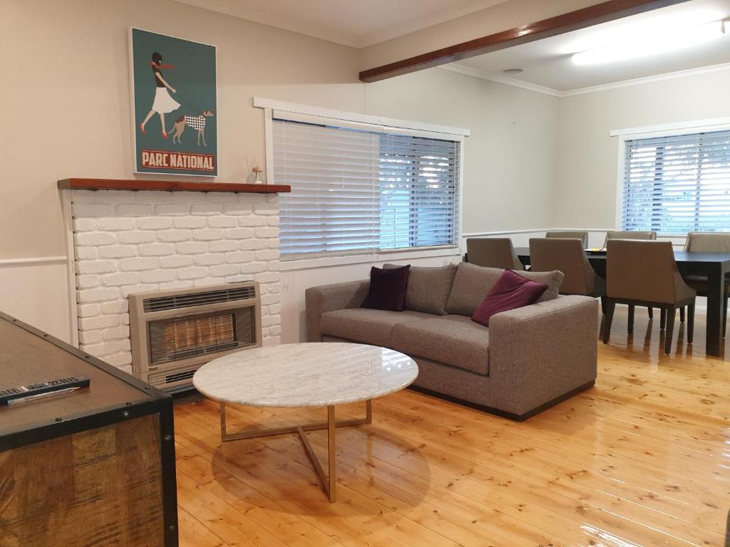 a living room with a couch and a fireplace at Miner's Retreat in Miners Rest
