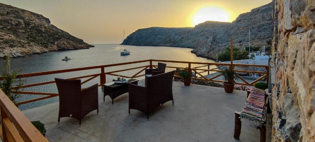 a balcony with a table and chairs overlooking a river at Cheronissos View in Sifnos