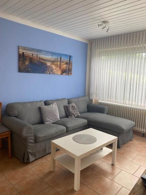 a living room with a couch and a table at Feriengarten Dahme W 22 in Dahme