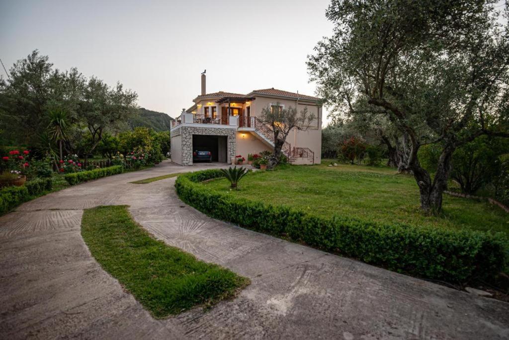 a house with a driveway in front of a house at Luxury Rustic Villa Mountain View in Lefkada Town
