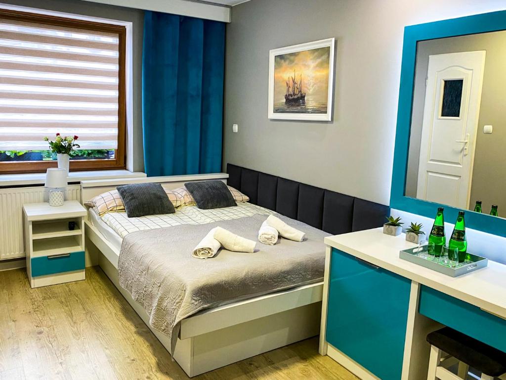 Schlafzimmer mit einem Bett, einem Schreibtisch und einem Fenster in der Unterkunft Villa Dana in Łeba