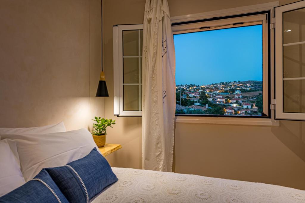 a bedroom with a window with a view of a city at Vardakis house in Volimes