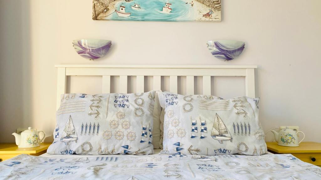 a bed with blue and white sheets and pillows at APARTELLO Modern Apartment - Balkan Breeze 7 in Sunny Beach