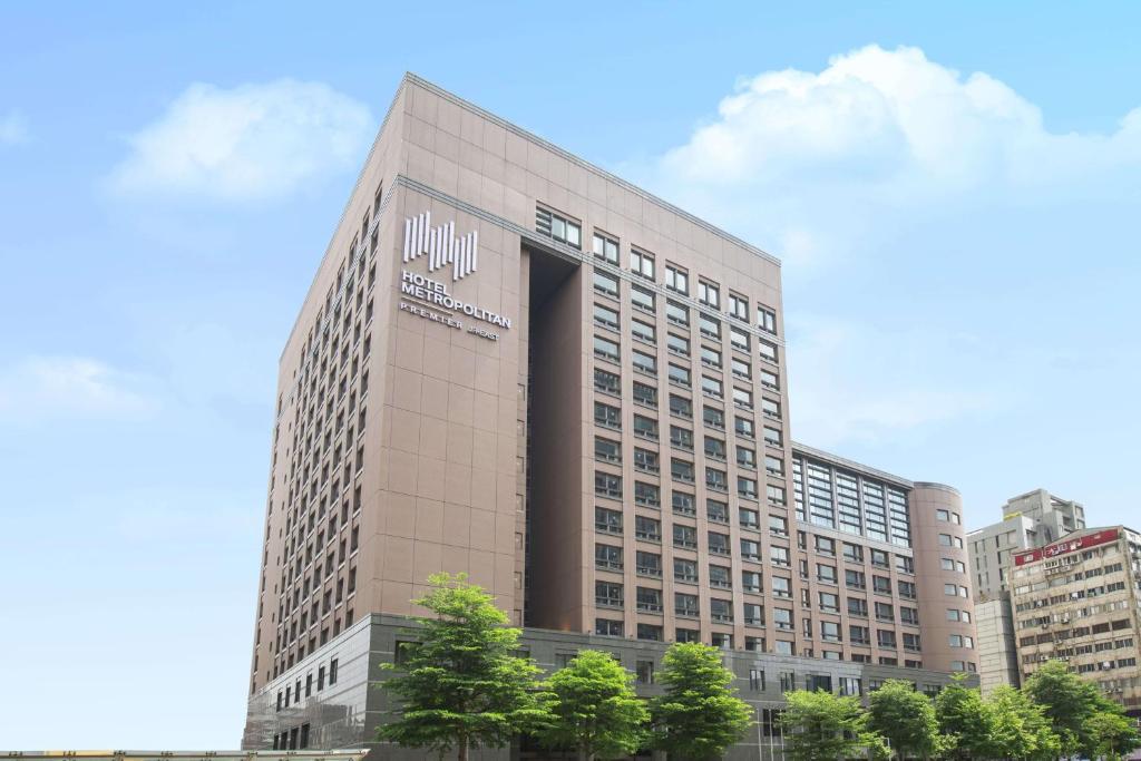 a tall building with a sign on the side of it at Hotel Metropolitan Premier Taipei in Taipei