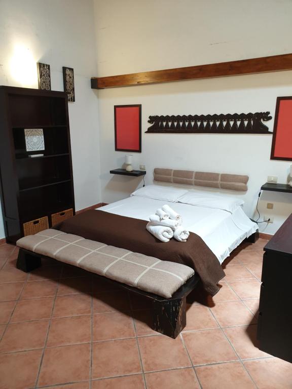 a bedroom with a large bed with two towels on it at Casa Bellini in Palermo