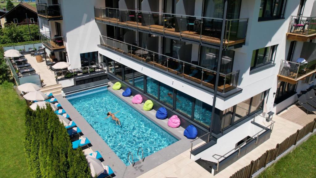 an aerial view of a building with a swimming pool at Hotel Sonnblick in Kaprun