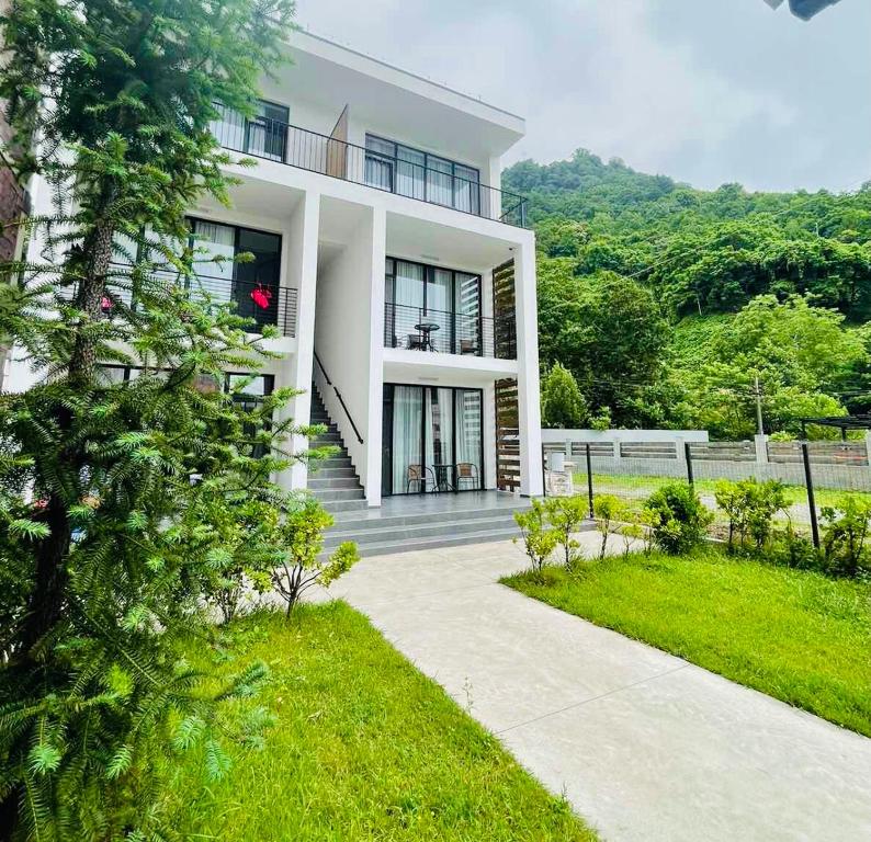 a white house with a pathway in front of it at Citro Villa in Gonio