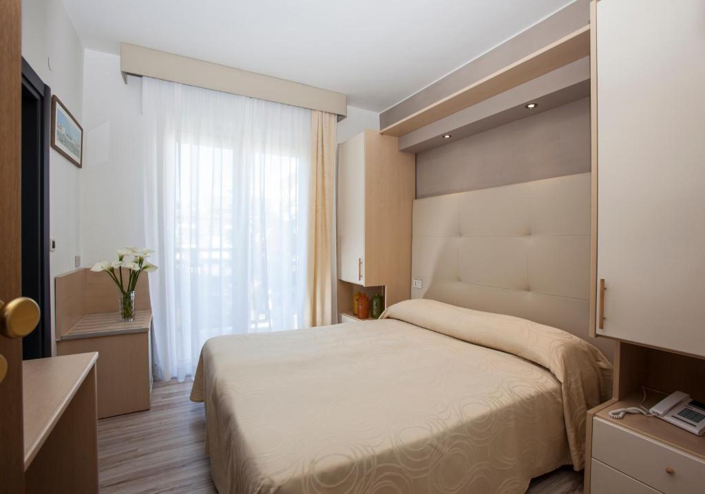 Postel nebo postele na pokoji v ubytování Hotel Torino