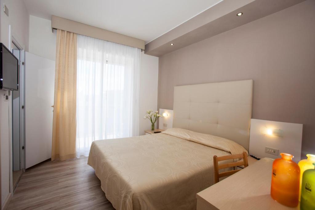 Postel nebo postele na pokoji v ubytování Hotel Torino