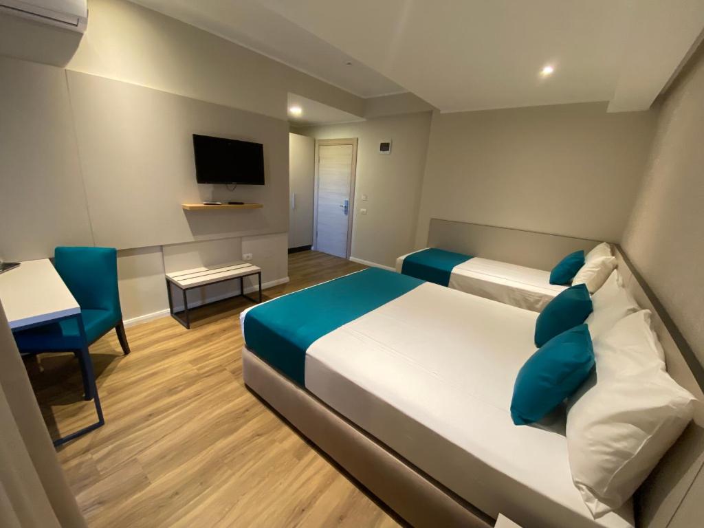 Postel nebo postele na pokoji v ubytování Hotel Rhodos